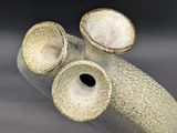 a close up of a vase with two holes in it