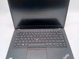 a black laptop with a red button on the keyboard