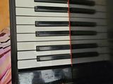 a black and white piano and a record on a table