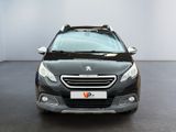 the front view of a black peugeot v - cross parked in a showroom