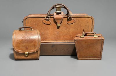 three pieces of luggage sitting next to each other on a gray surface