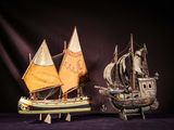 two model ships that are on display on a table