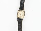 a watch that is laying on a white surface