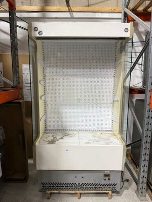 an empty refrigerator in the middle of a room