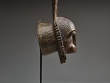 an image of a wooden sculpture of a man ' s head on a stand