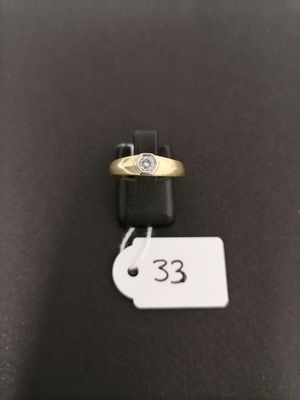 a close up of a gold ring with a diamond on it
