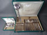 a green case with silverware in it on a table