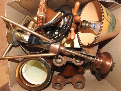 a cardboard box filled with assorted items and tools