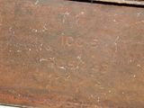 a rusted metal box sitting on a white surface