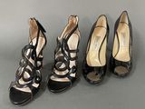 three pairs of women ' s black high heel shoes on a gray surface