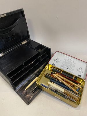 a box of pens and a box of pencils on a table
