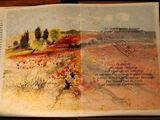 an open book with a picture of a landscape in it