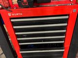 a red tool box with tools on top of it