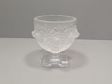 a clear glass bowl on a white table with a gray background