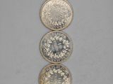three different types of coins sitting on top of each other
