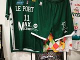 two jerseys hanging on a wall next to a framed picture