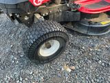a lawn mower that is sitting on the ground