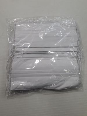 a bag of folded white napkins on a table