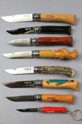several different types of knives are lined up on a table