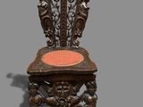 an old wooden chair with a red cushion on top of it