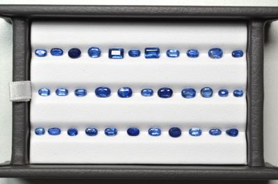 a display of blue sapphires in a black box