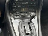 a car dashboard with a steering control and a dash button