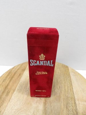 a small red box on top of a wooden table