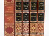 quatre livres sont alignés sur une surface blanche