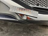 a sticker on the bumper of a car that has a sticker on it