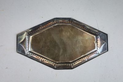 a silver tray with a mirror on it on a table