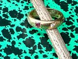 a ring on a stick with a diamond on it