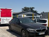 a black bmw car parked in a parking lot