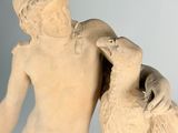 a statue of a boy with a bear and a dog