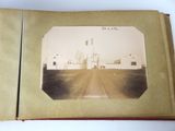 an old photo of an open book with a picture of a building in the background