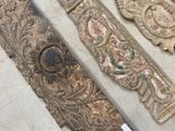 three pieces of carved wood sitting on a table