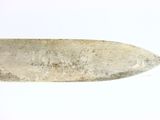 a very old knife that is on a white surface