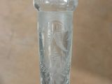 a glass vase with a design on it on a table