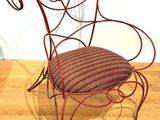 a red chair with a striped cushion on it