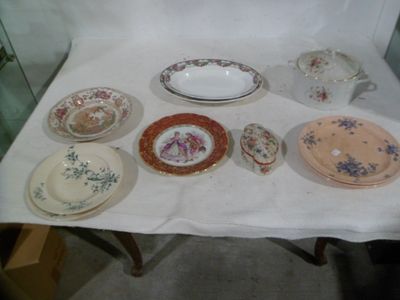 many plates and bowls sitting on a white table