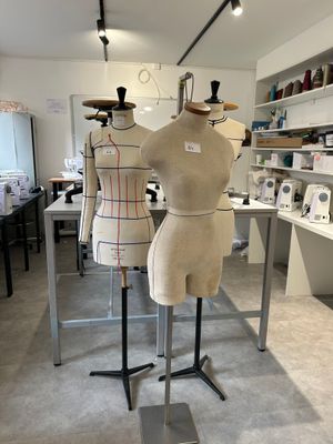 three mannequins on display in a room