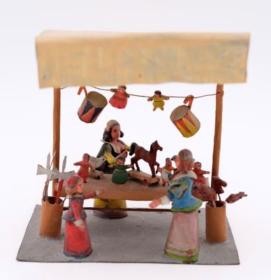 figurines of people sitting at a table with a sign above them