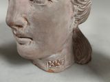 a statue of a woman with a flower in her hair