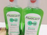two bottles of fluocaril are sitting on a bamboo mat