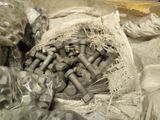 many nuts and bolts in a bag on a table