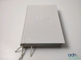 a white book sitting on top of a white table
