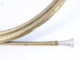 two brass pipes that are next to each other on a white surface