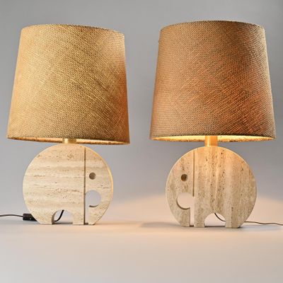 pair of wooden elephant lamps with burlock lampshads on them