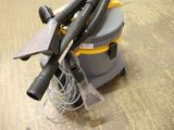 a yellow and black vacuum on a wooden floor