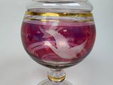 a glass jar with a bird design on it