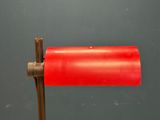 a close up of a red lamp on a metal pole